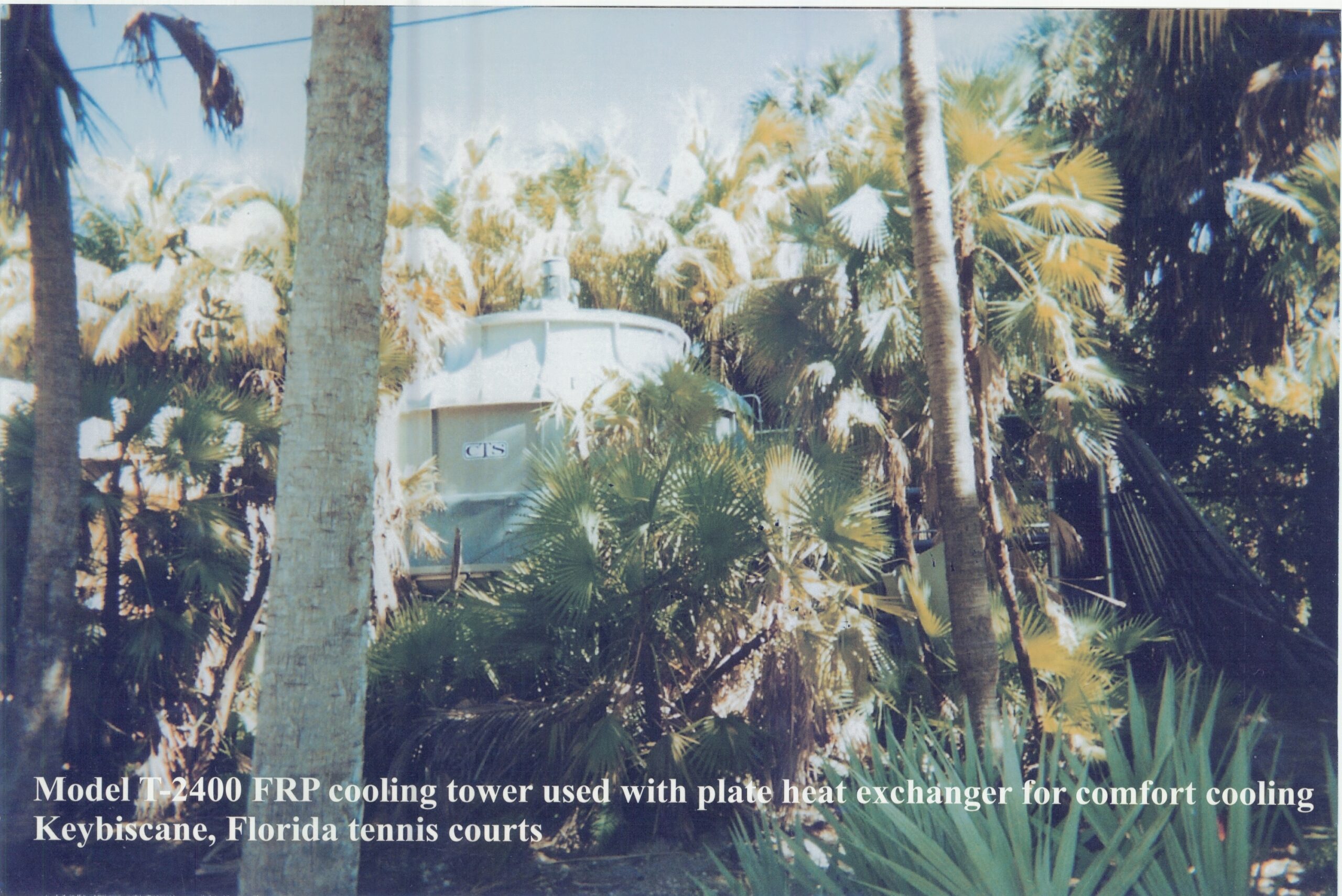 CTS Model T-2400 FRP cooling tower among palm trees, used with a plate heat exchanger for comfort cooling at Key Biscayne, Florida tennis courts
